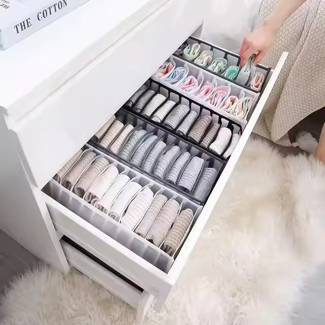 Clothes organiser with multiple compartments for neatly storing underwear, socks, bras, and scarves in drawers.